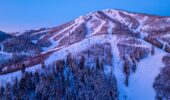 A chairlift with a scenic snow covered mountain backdrop at Deer Valley