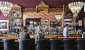 Guests enjoying a drink at the Hotel Jerome bar, Aspen USA