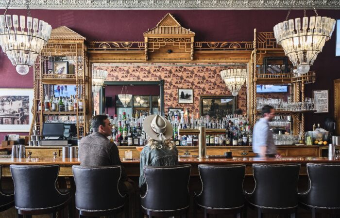 Guests enjoying a drink at the Hotel Jerome bar, Aspen USA