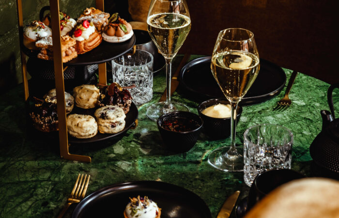 A high tea with glasses of wine at the Hotel Jerome, Aspen USA