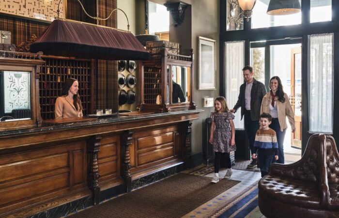 A family walking into the Hotel Jerome lobby, Aspen USA