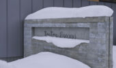 Snow-covered Tsu Tsu Furano accommodation sign at entrance in Furano Japan