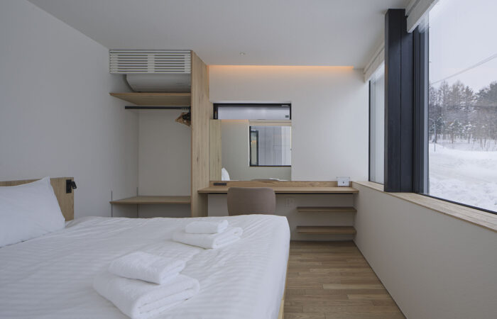 Tsu Tsu Furano modern bedroom with clean minimalist interior in Furano Japan