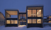 Tsu Tsu Furano accommodation exterior at night surrounded by snow in Furano Japan