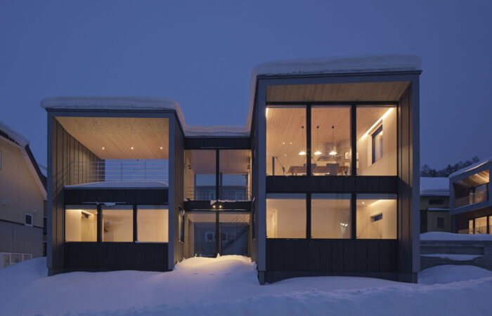 Tsu Tsu Furano accommodation exterior at night surrounded by snow in Furano Japan