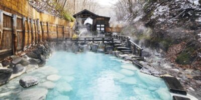 Large outdoor onsen bath surrounded by nature in Zao Onsen Japan