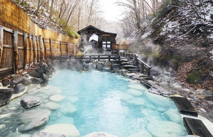 Large outdoor onsen bath surrounded by nature in Zao Onsen Japan