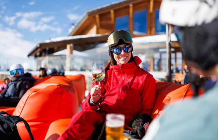 Skier enjoying the après-ski atmosphere in Méribel, France.