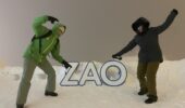 Skiers posing beside the Zao sign on the ski slopes in Zao Onsen Japan