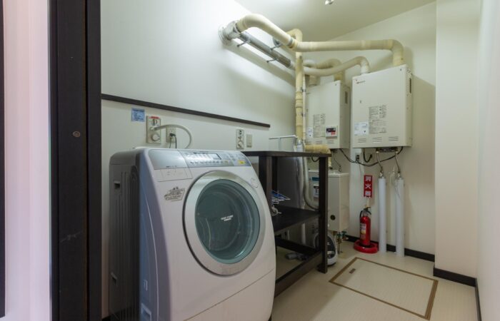 Laundry room facilities at Shochikubai accommodation in Furano Japan
