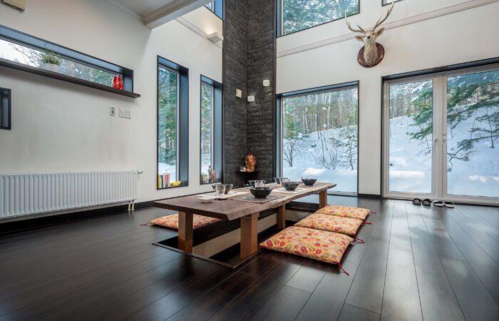 Traditional Japanese dining room with low table and floor cushions at Shochikubai accommodation Furano
