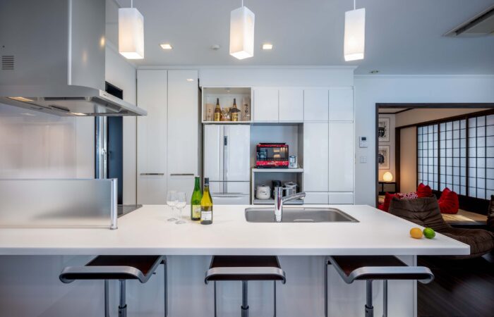 Kitchen with breakfast bar seating at Shochikubai accommodation Furano
