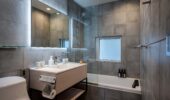 Bathroom with bath, shower and toilet at Arthouse Apartments Furano