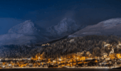 Night view of St. Moritz village illuminated in the Swiss Alps during winter.