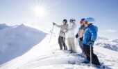Group of skiers admiring mountain views while skiing in Méribel, France
