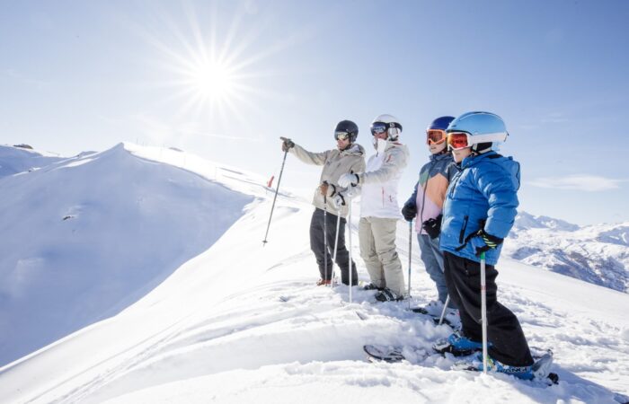 Group of skiers admiring mountain views while skiing in Méribel, France