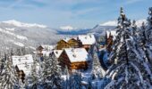 Snow-covered alpine lodge buildings in Méribel, France during winter.