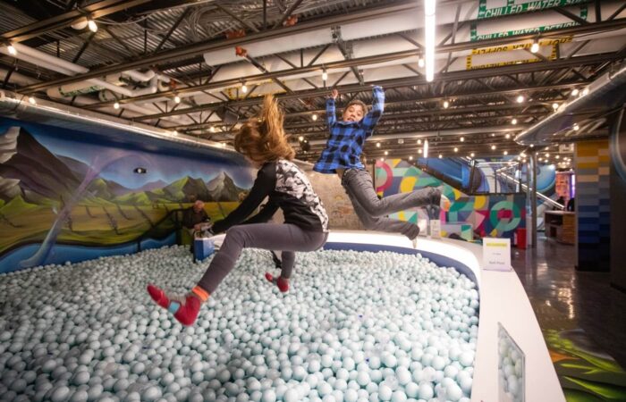 Children playing in a ball pit at The Collective Snowmass