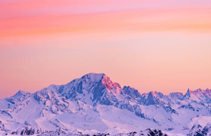 Sun rise over the snow covered mountains from Val Thorens France