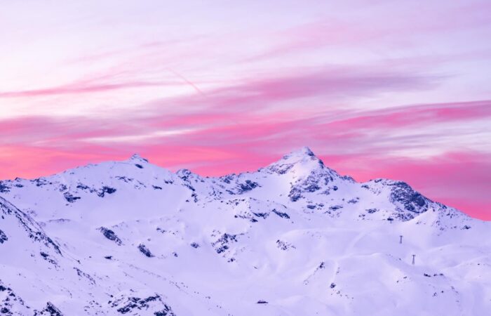 Sun rise over the snow covered mountains from Val Thorens France