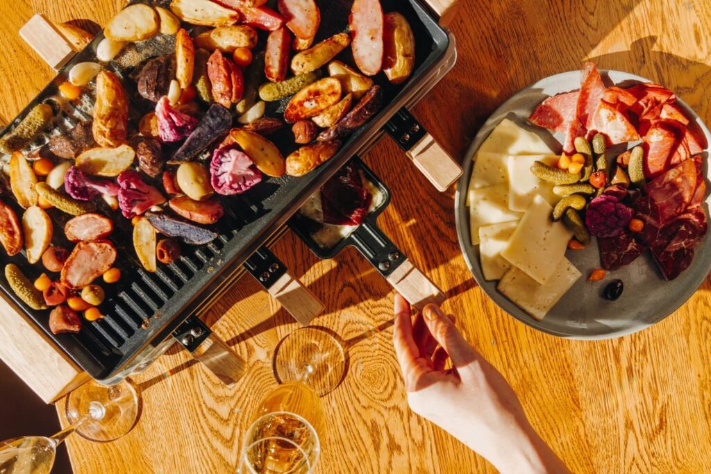 Apres ski feast with wine glasses at Cloud 9 Alpine Bistrot Aspen
