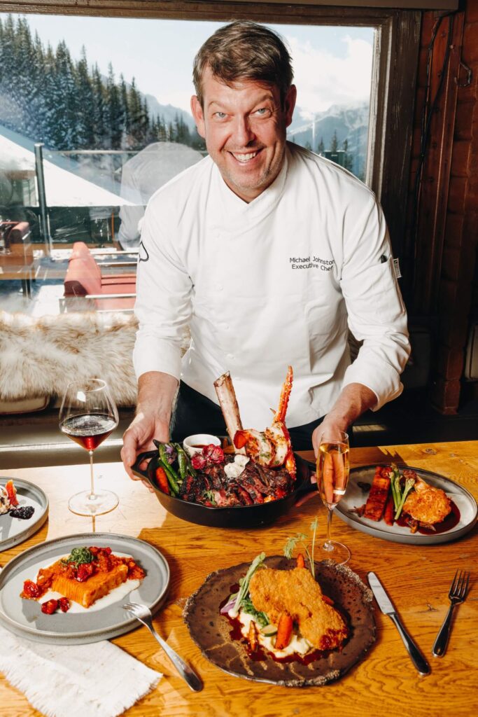 Chef presenting hearty alpine meals at Cloud 9 Aspen bistrot