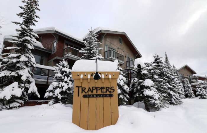 Outside view of snow covered Trapper's Landing accommodation at Sun Peaks