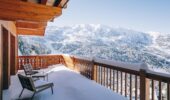 Snow covered balcony with a view at Hotel Le Coucou Meribel France