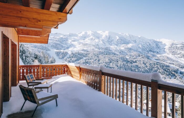 Snow covered balcony with a view at Hotel Le Coucou Meribel France