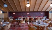 View of empty restaurant set for dining at Hotel Le Coucou Meribel France