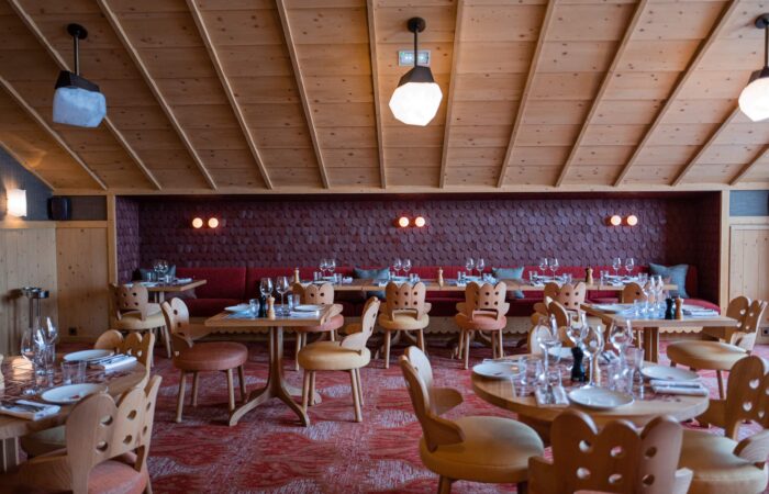 View of empty restaurant set for dining at Hotel Le Coucou Meribel France