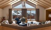 Chalet salon with a view of snow covered mountains at Hotel Le Coucou Meribel France