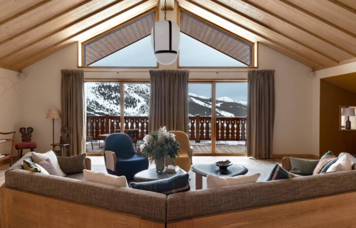 Chalet salon with a view of snow covered mountains at Hotel Le Coucou Meribel France