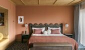 View of a double bed in a suite at Hotel Le Coucou Meribel France