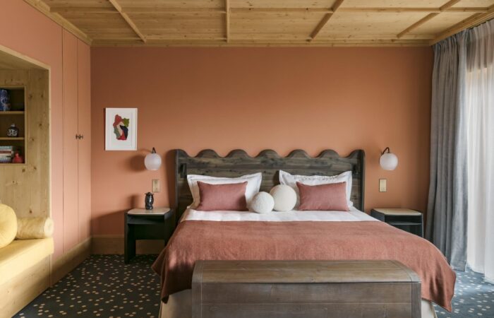 View of a double bed in a suite at Hotel Le Coucou Meribel France