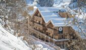 Exterior shot of the Hotel Le Kaila covered in snow