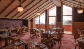 An empty restaurant interior view set for dining at Hotel Le Coucou Meribel France