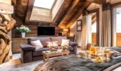 Bed and living area of luxury hotel room at Hotel Le Kaila Meribel France