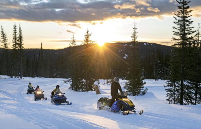 holiday makers riding snow mobiles at Sun Peaks ski resort