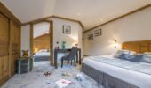 La Chaudanne Hotel & Spa suite lounge area with beds, carpted floor and desk