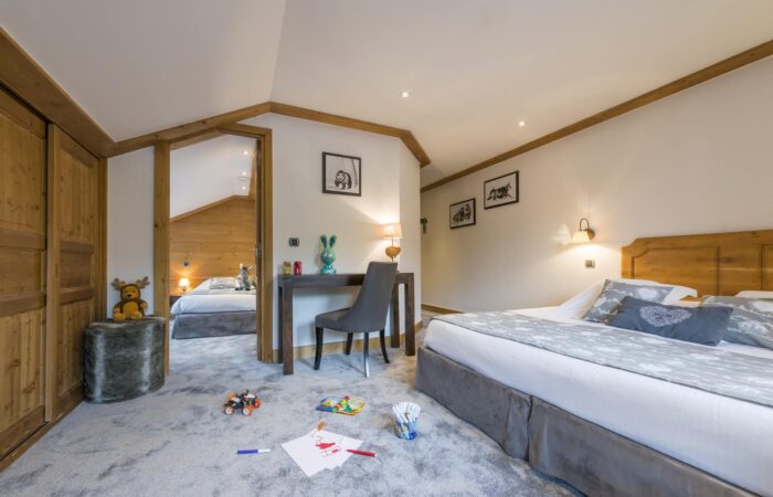 La Chaudanne Hotel & Spa suite lounge area with beds, carpted floor and desk
