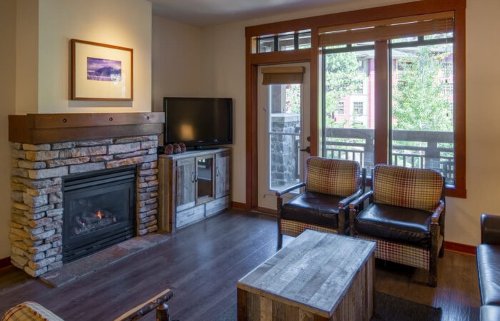 Living area with fireplace in room at The Village Lodge Mammoth