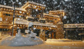 External night view of The Village Lodge Mammoth with new falling snow