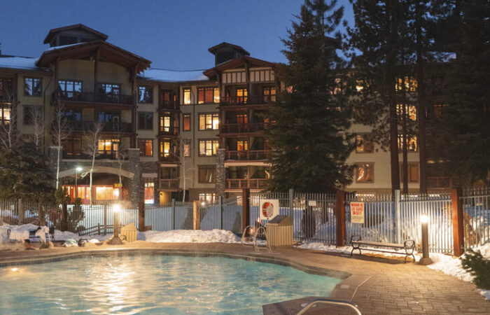 External night view by the pool of The Village Lodge Mammoth